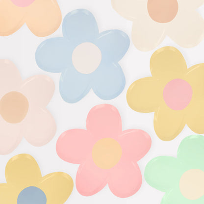 Multicoloured pastel daisy plates on a white background