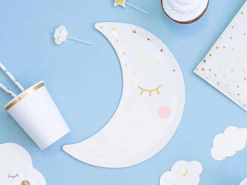 flat lay photo with moon shaped paper plates and matching baby shower decor