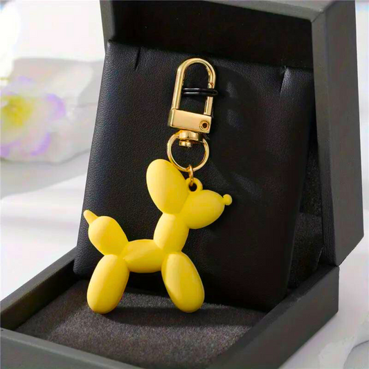 balloon dog keychain in a bright yellow colour 