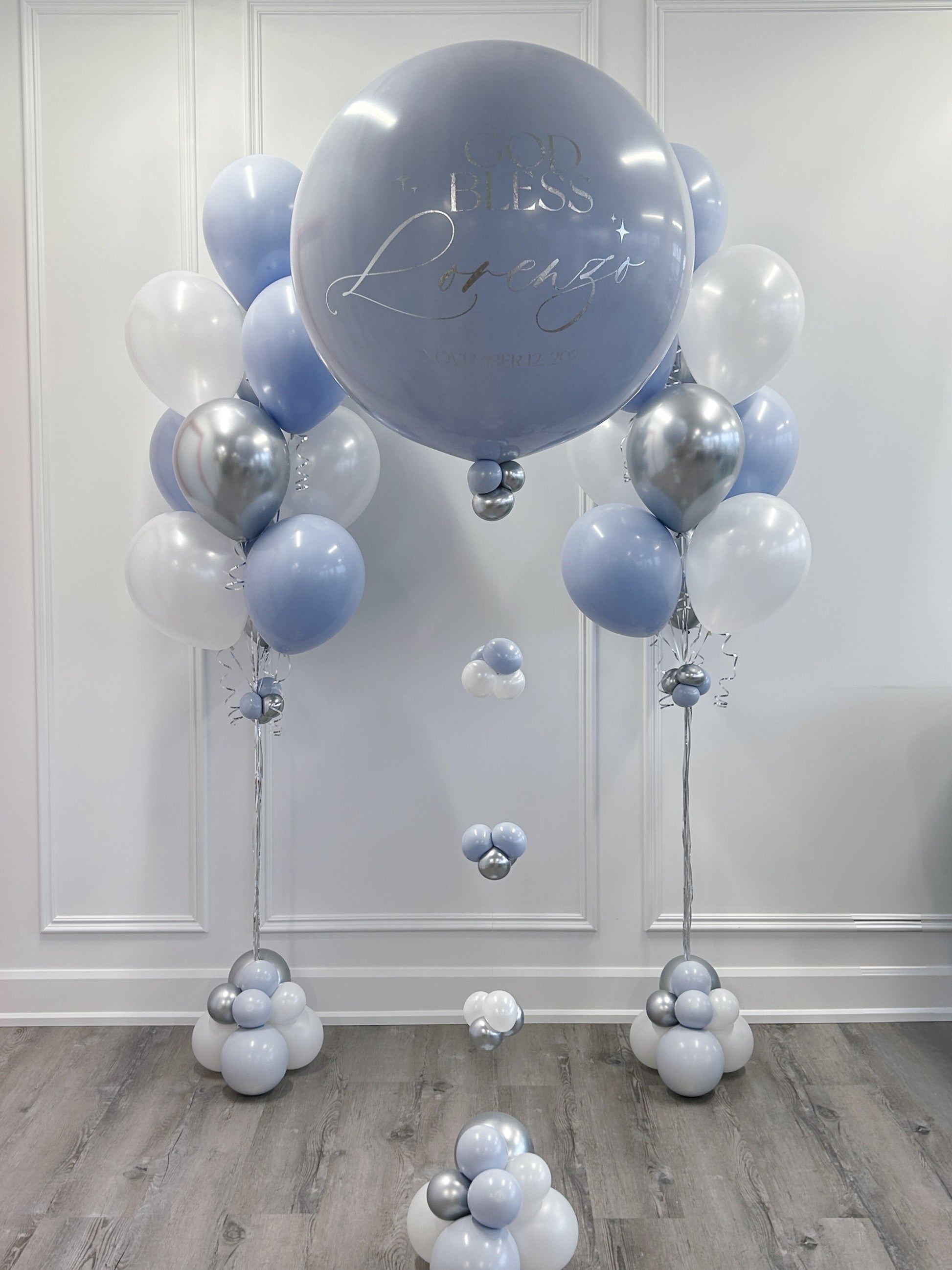 blue white and silver balloon bundles for baptism