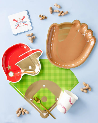 flat lay photo with baseball themed party supplies including a mitt shaped paper plate, baseball designed cup and all star cocktail napkin