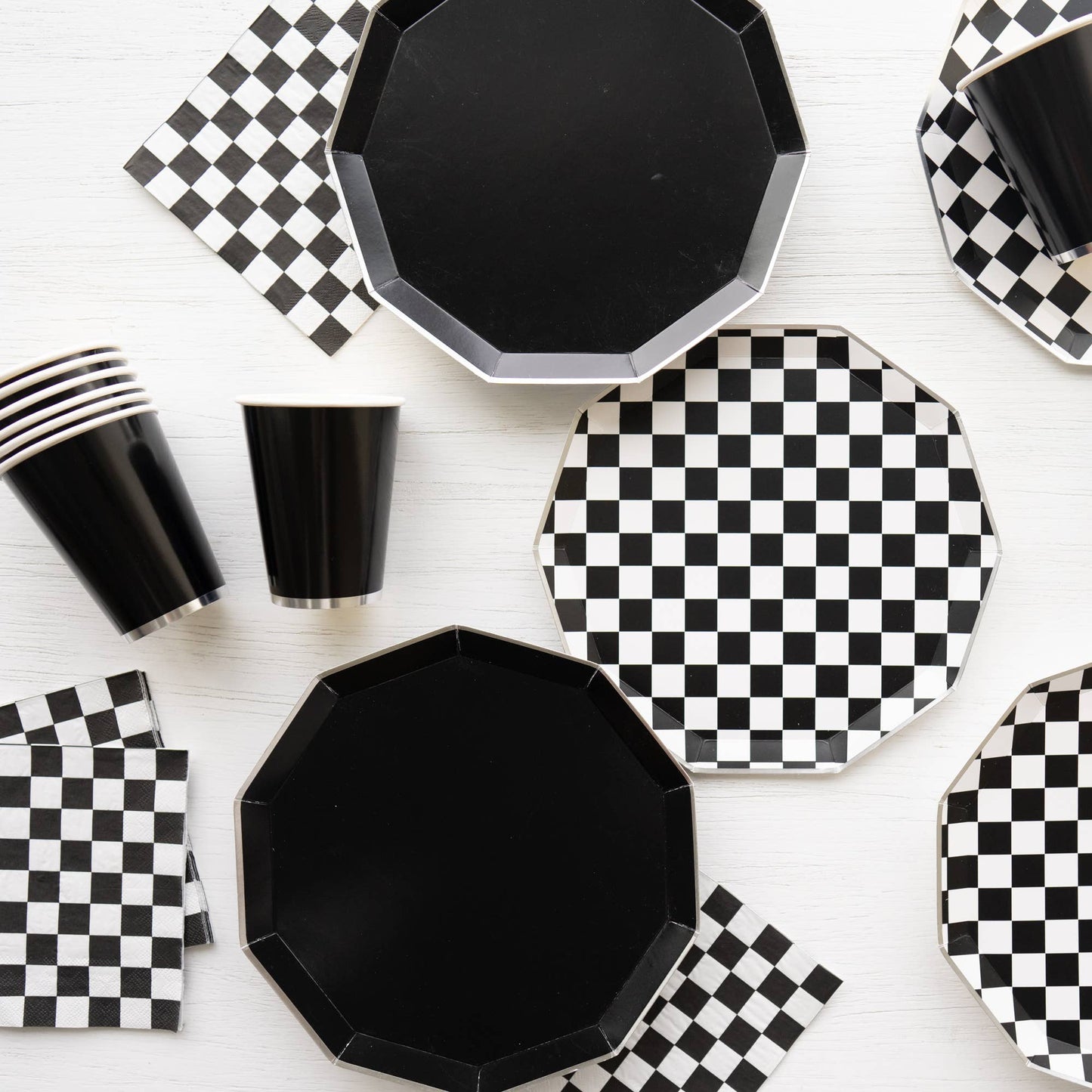 black paper plates paired with checkered black plates and napkins 