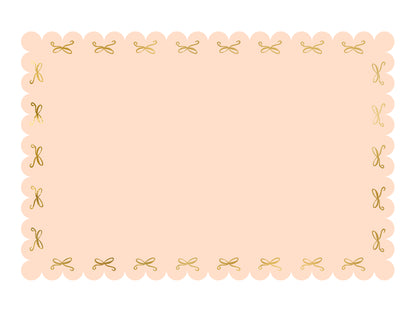 scalloped pink paper table cloth with gold foil bows 