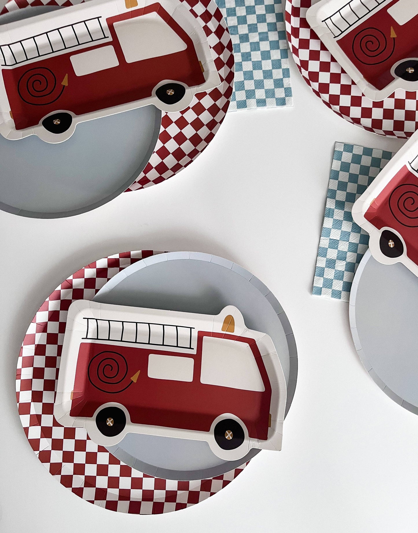 checkered blue dinner napkins displayed with a firetruck paper plate