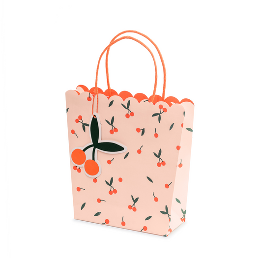 peach coloured gift bag with coral coloured cherry pattern