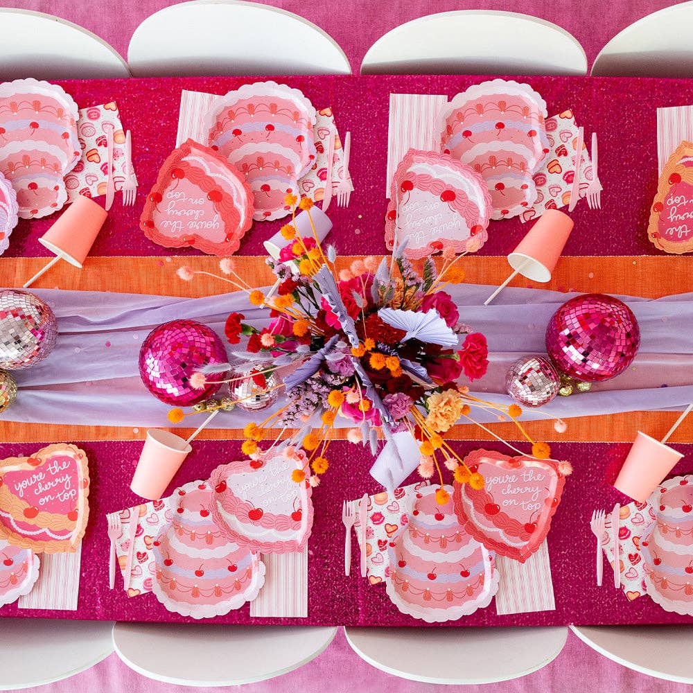 valentine's day table setting with cherry themed vintage cake plates and napkins