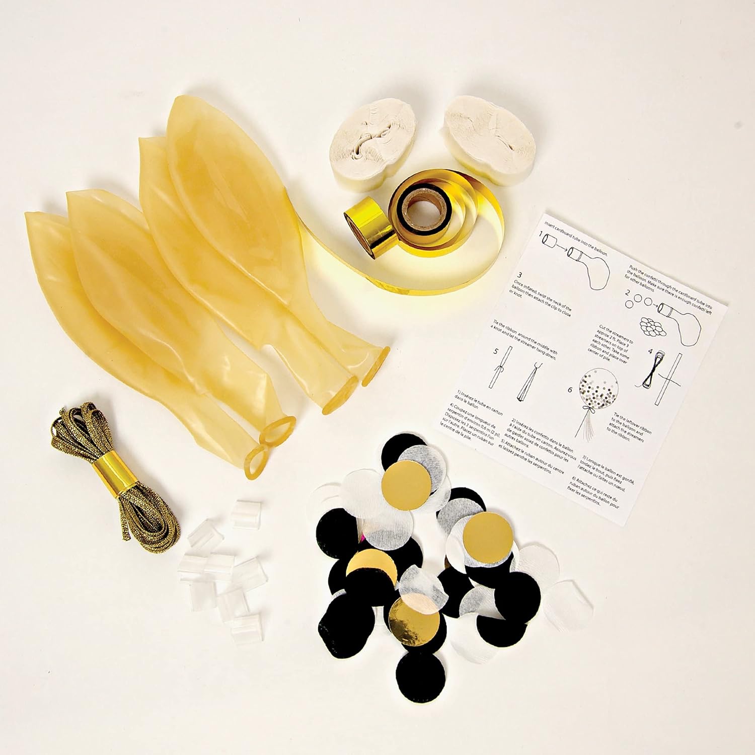 flat lay of product contents including clear balloons, confetti, ribbon, streamers and instruction