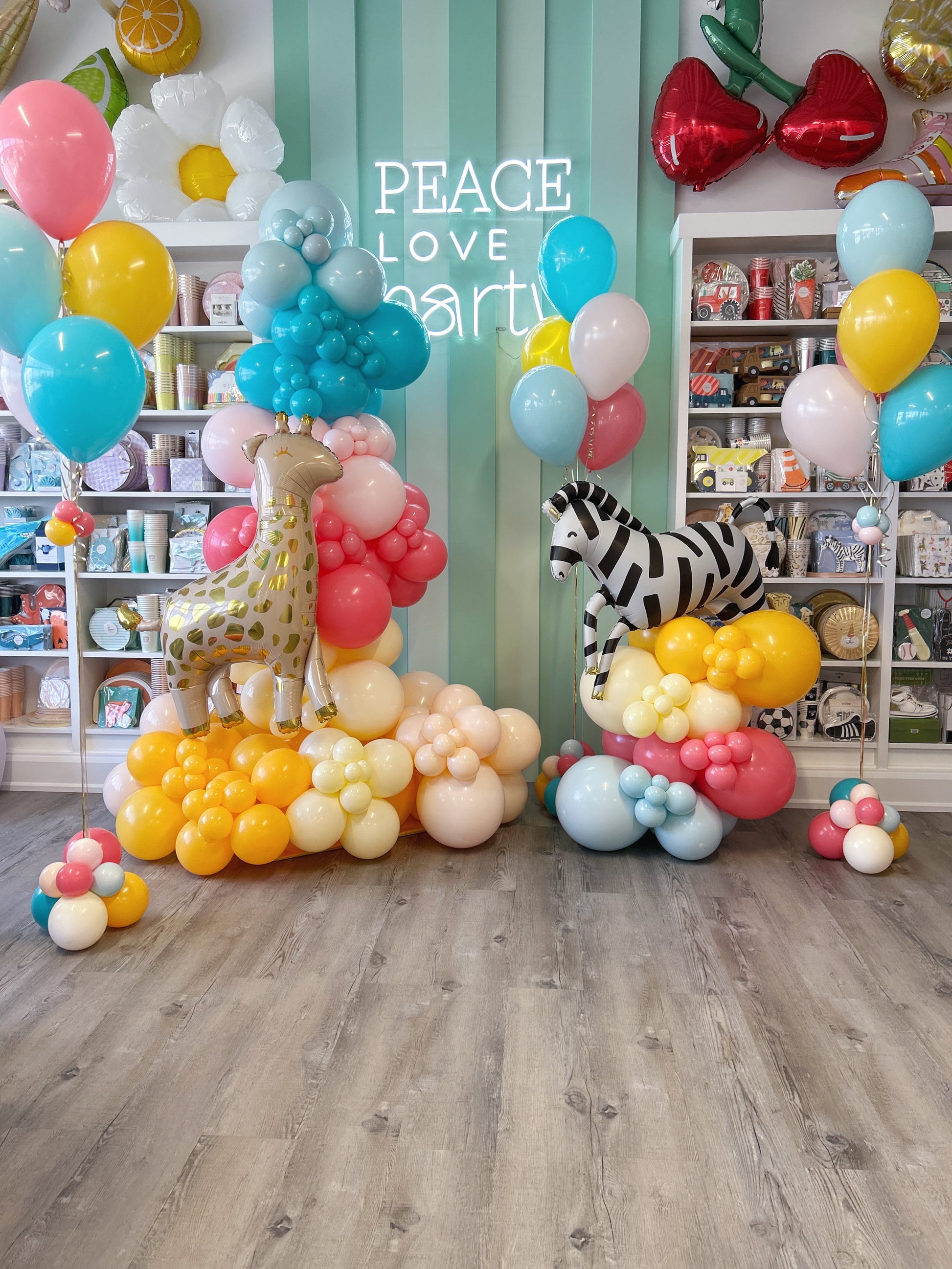 colourful party animal balloon garland and helium balloon bundles to match 