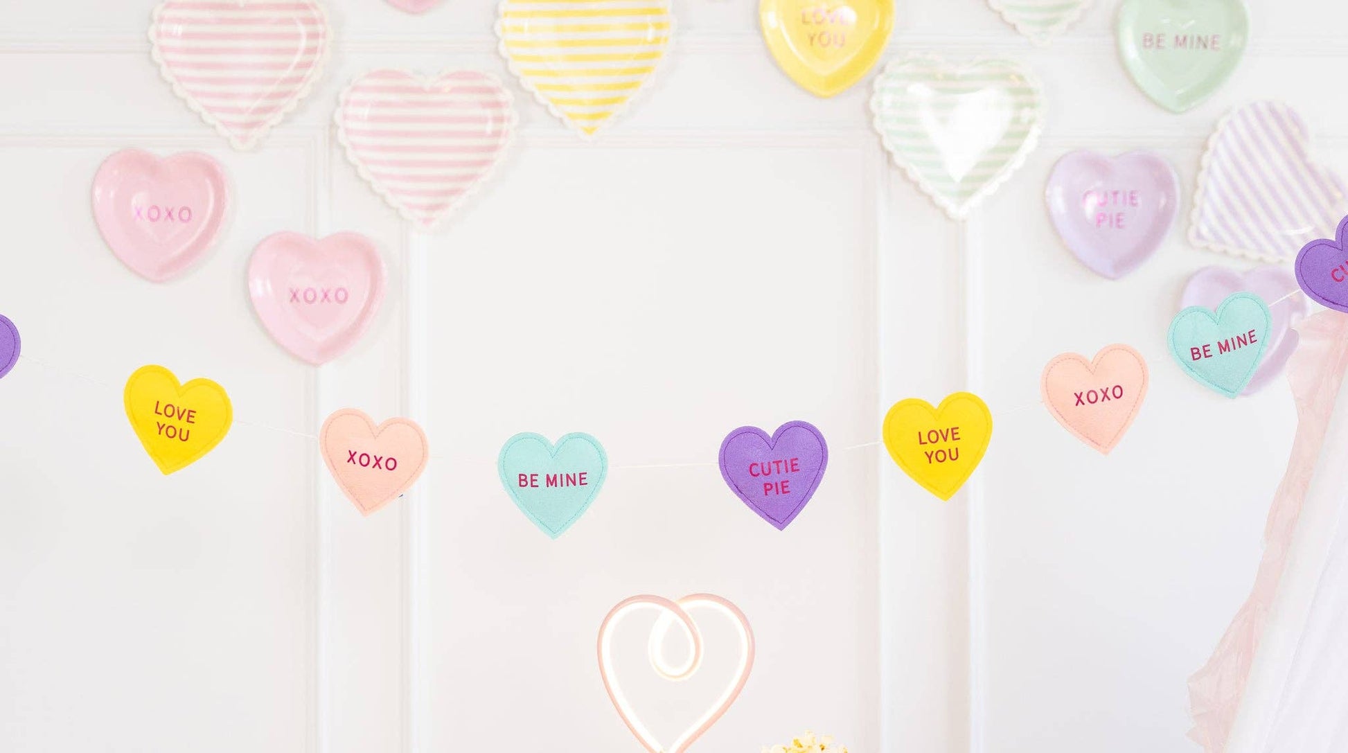 colourful puffy conversation hearts felt banner. red script and multi coloured hearts - purple, peach, yellow and blue. 