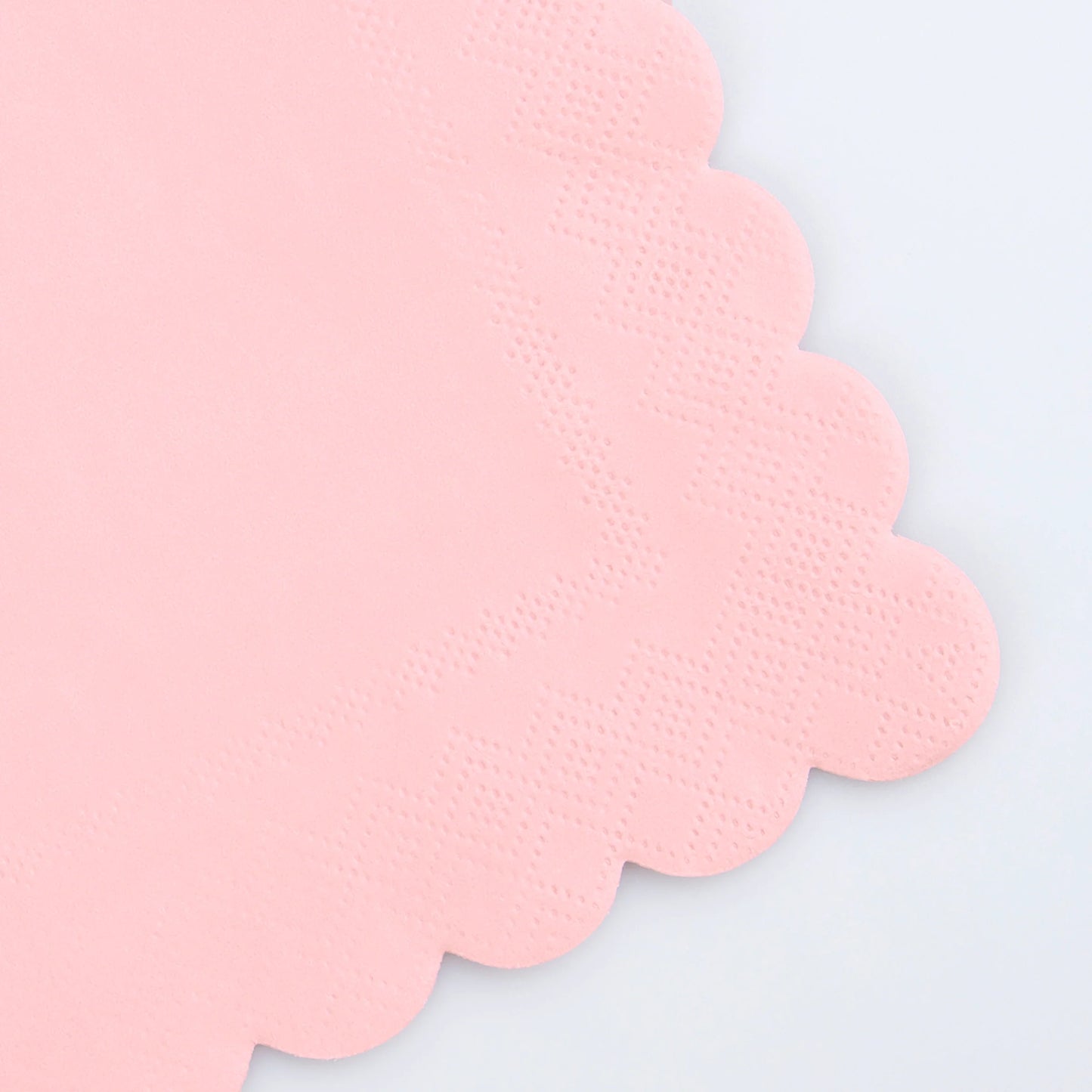 close up of large pink scallop napkins
