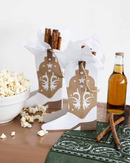 cowboy boot shaped favour bags displayed with treats 