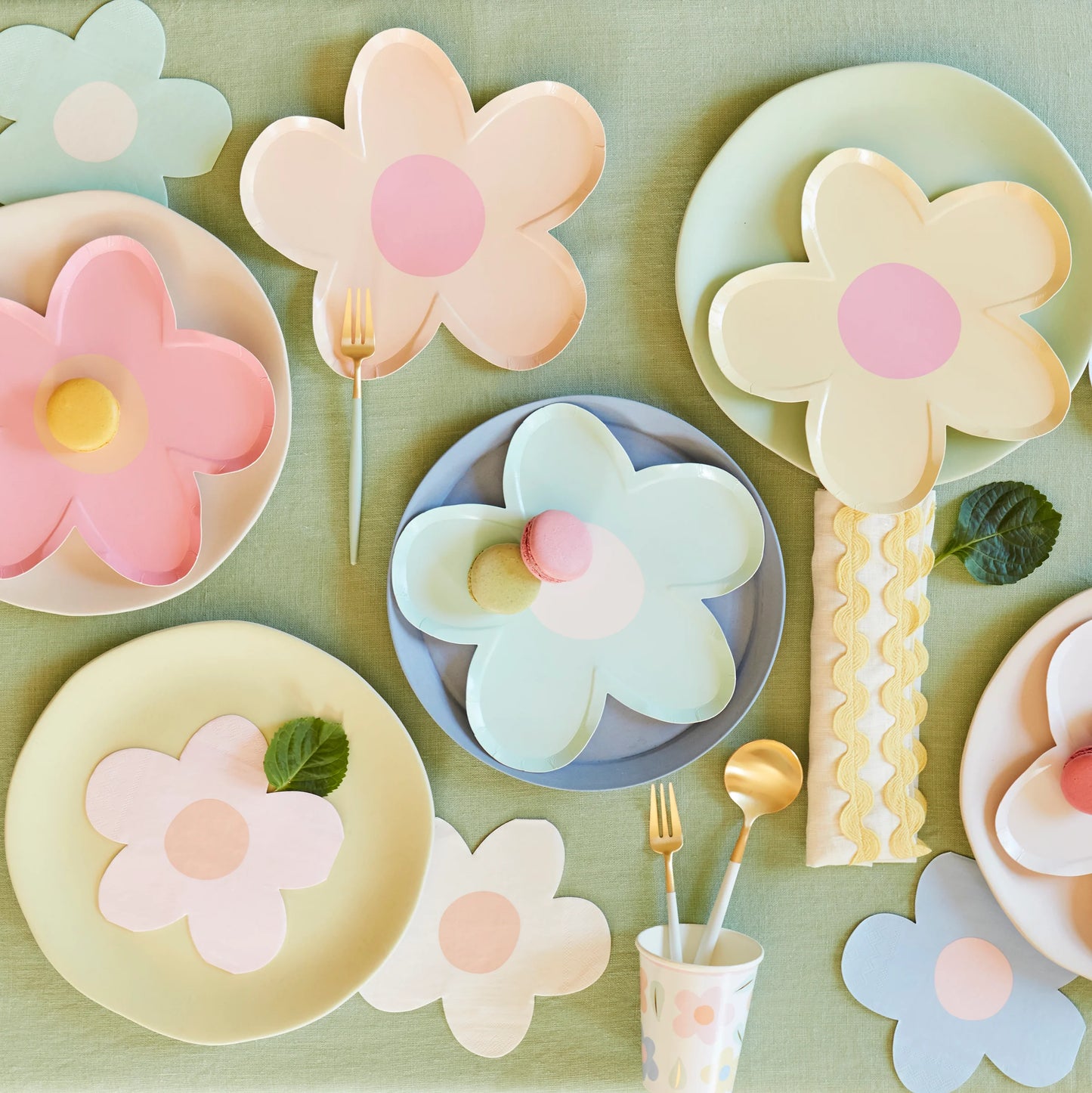 A table topped with colourful daisy shaped party supplies.