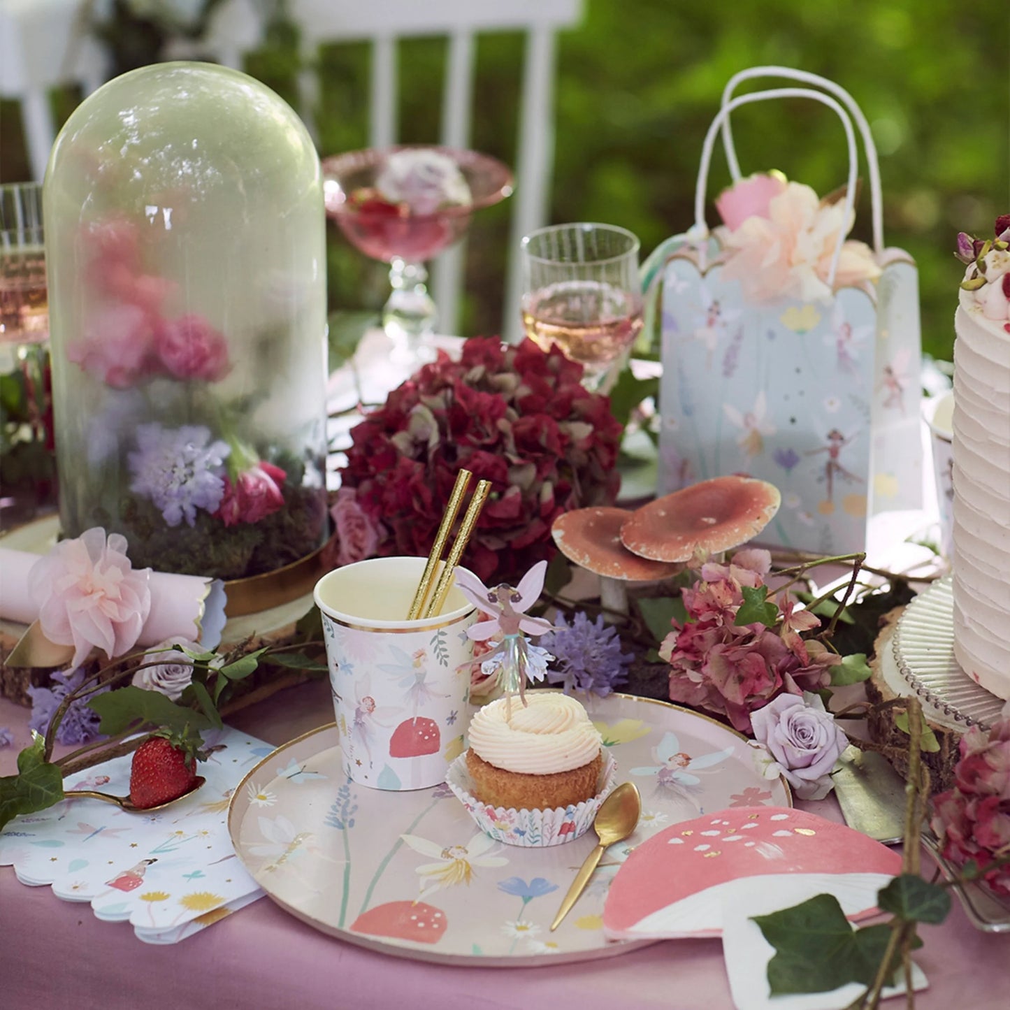 A table topped with fairy themed party decorations.