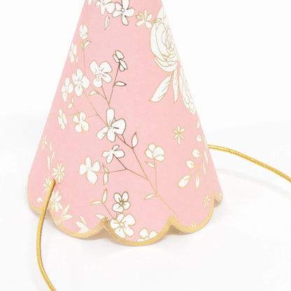 Paper party hat with floral design, scalloped bottom edge with gold details.