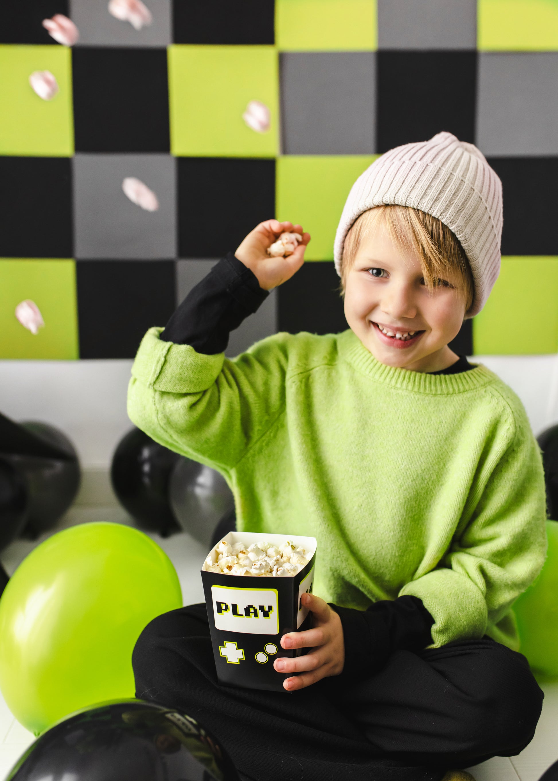 popcorn filled treat box, boy throwing the popcorn