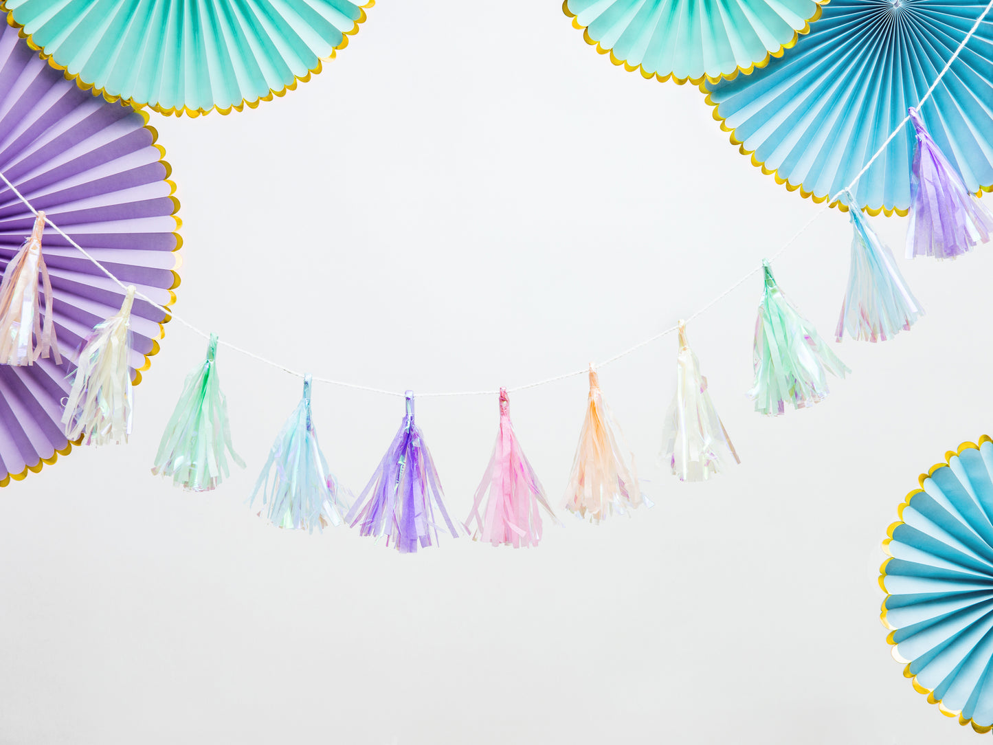 purple and blue paper party fans with iridescent tassel banner