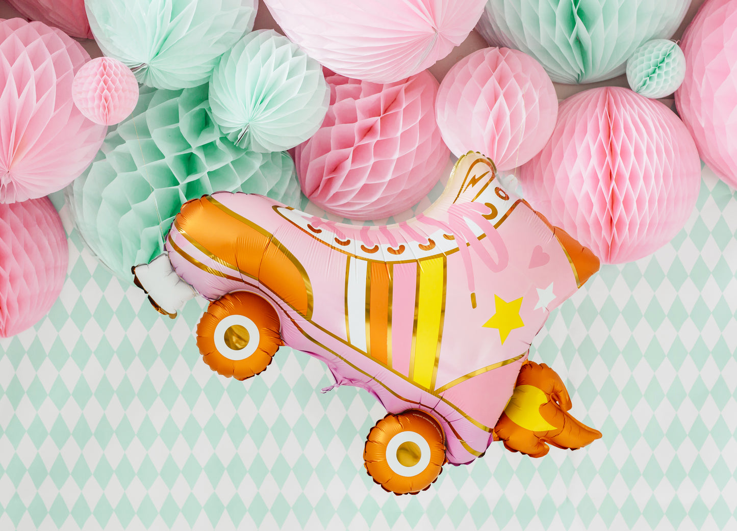 honeycomb backdrop with roller skate foil balloon