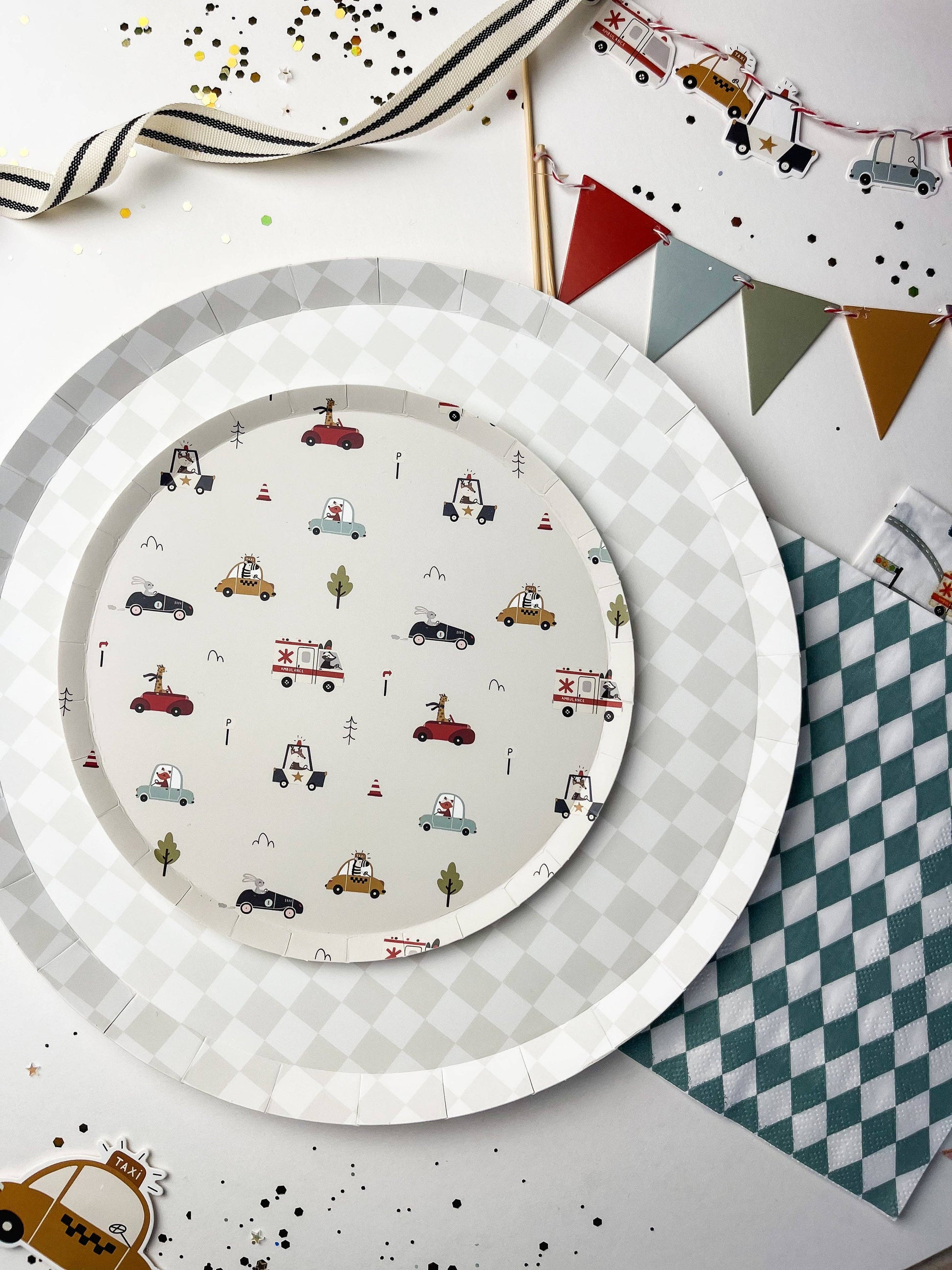 checkered white and grey paper plates paired with race car plate and checkered blue napkins