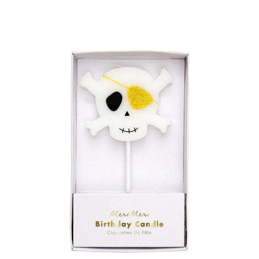 large skull and crossbones candle with gold glitter eyepatch