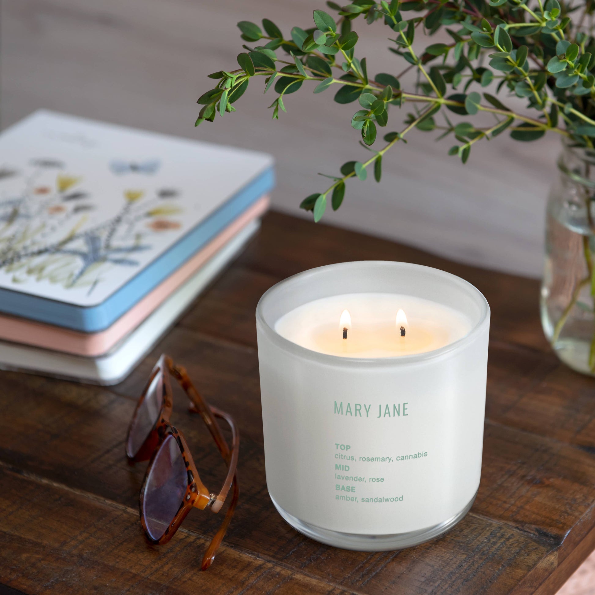 studio oh candle with books and plant