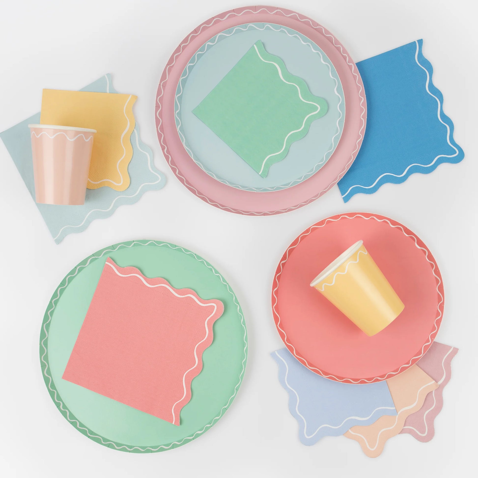 mixed wavy side plates, napkins, dinner plates and cups 
