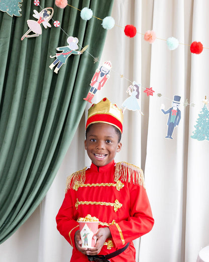 boy holding nutcracker party paper cup with popcorn 