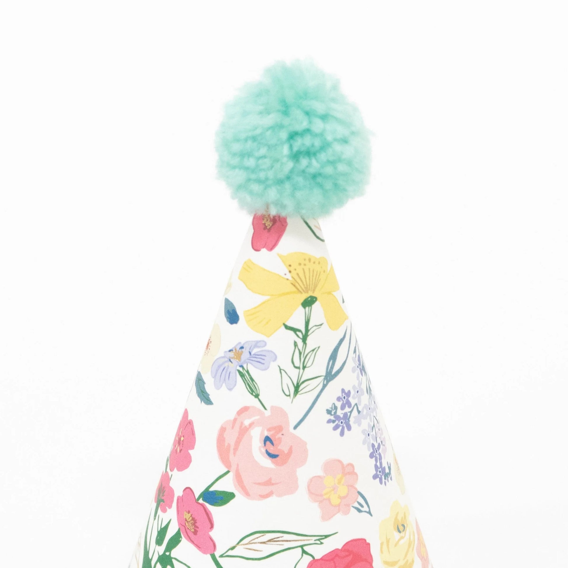 Paper party hat with colourful floral design and mint coloured pom pom.