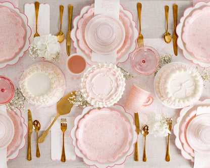 pembroke pink floral party supplies tablescape with matching charger, dinner + dessert plates and bow mini cakes 