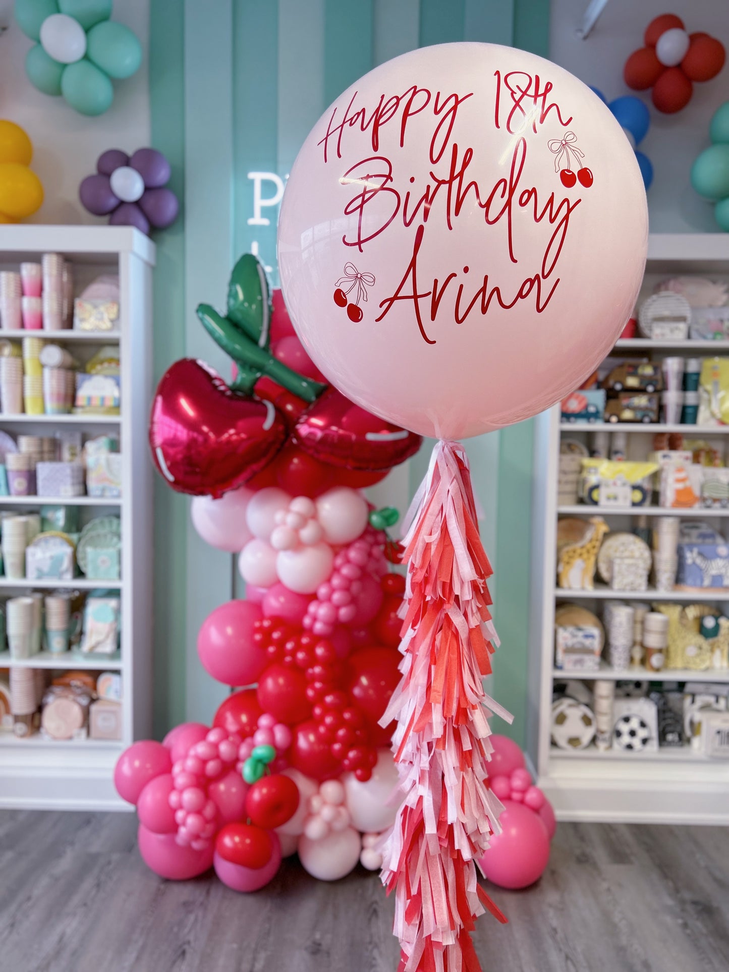 pink and red cherry balloon garland with a jumbo personalized latex balloon