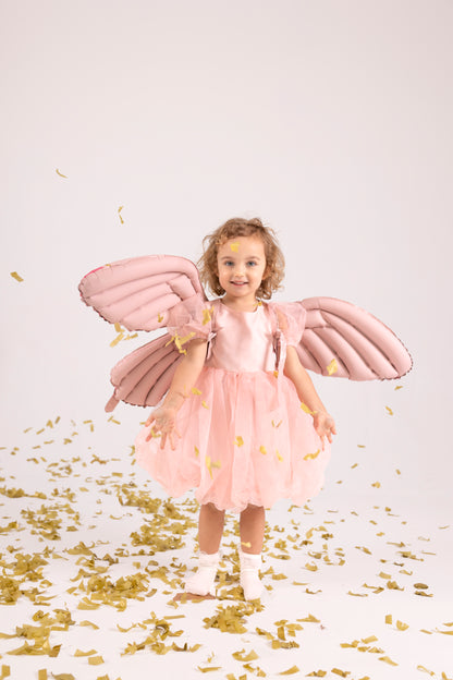 girl posing with foil balloon butterfly wings 