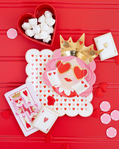 queen of hearts dinner napkins with matching plates and pink poker chips decor 