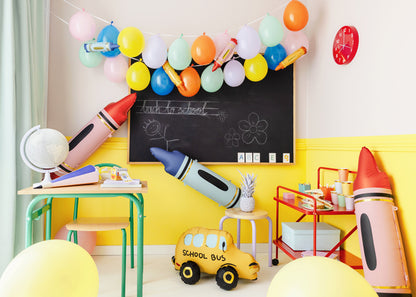 red crayons foil balloon displayed with school themed party supplies 