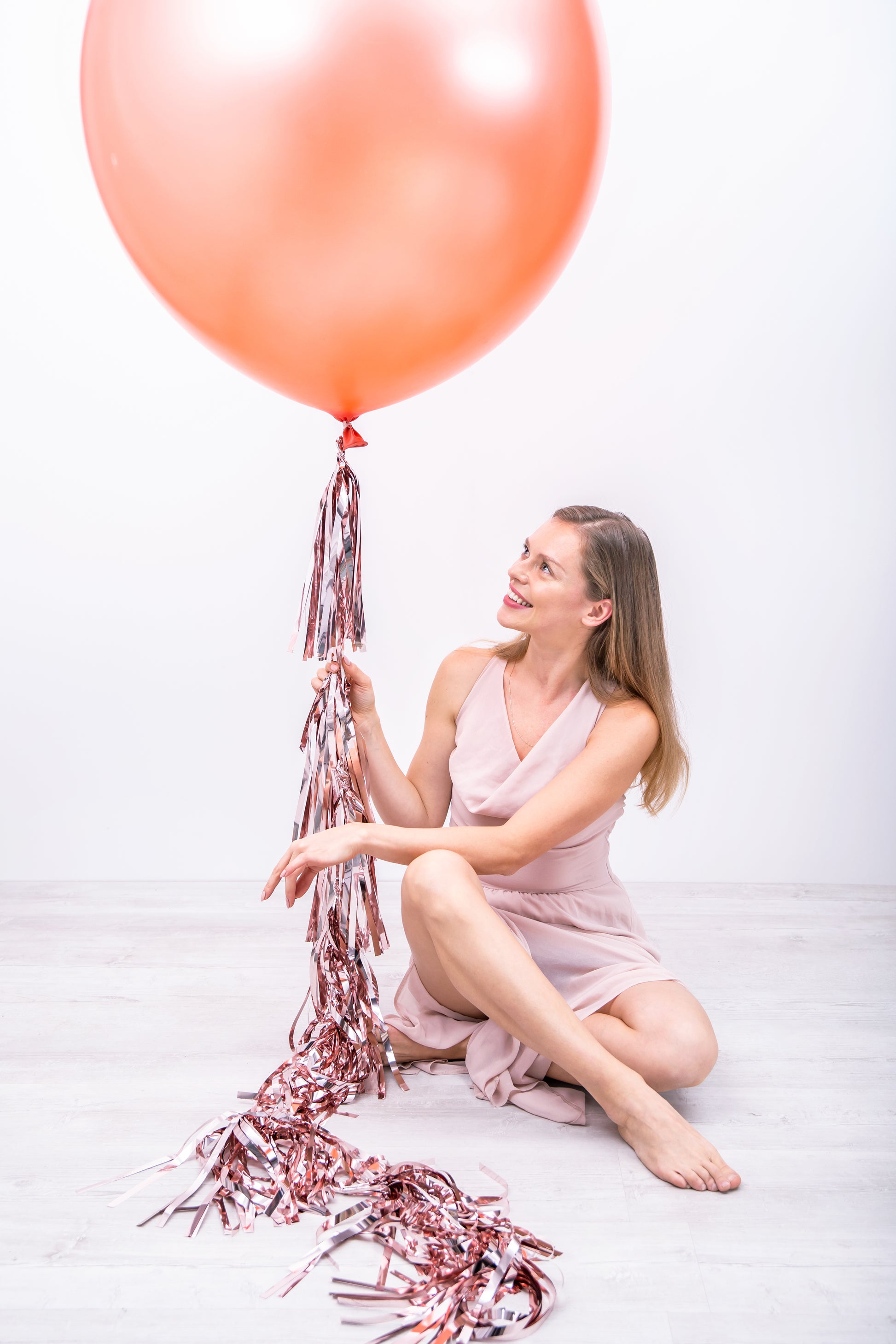 rose gold balloon tassel and model posing 