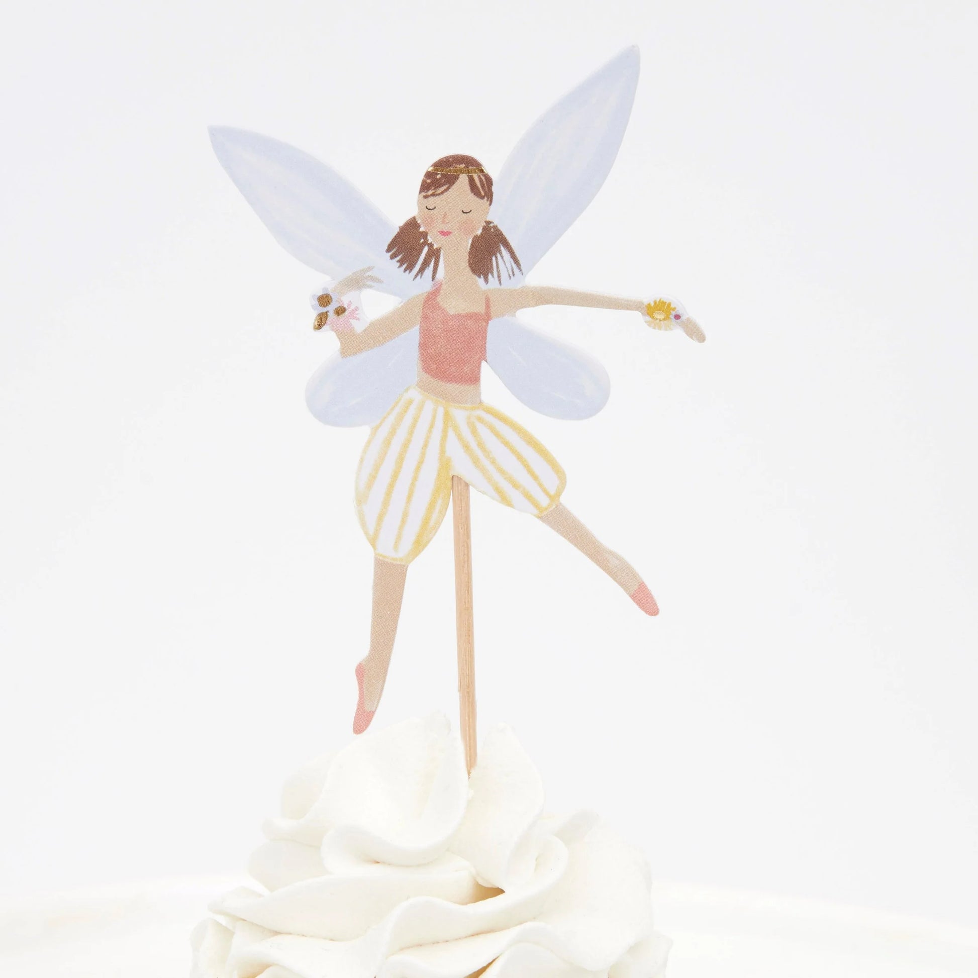 A cupcake with a fairy wearing a striped yellow skirt on top of it.