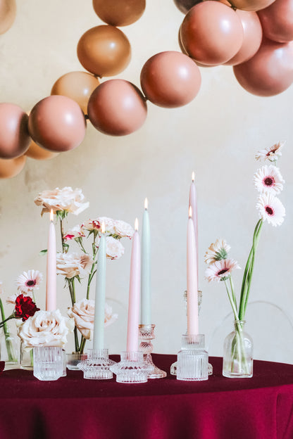 mixed tapered candles displayed with florals