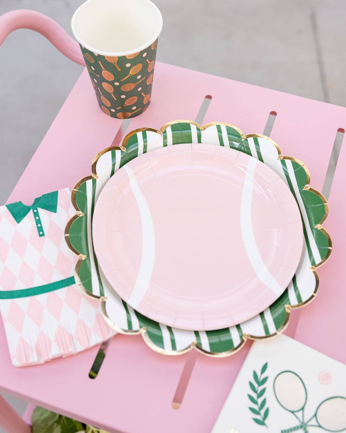 pink tennis ball paper plate setup with pink tennis dress fringe napkin and tennis ball cup