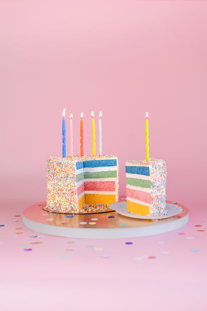 twisted colourful birthday candles on a 4 layer confetti cake 