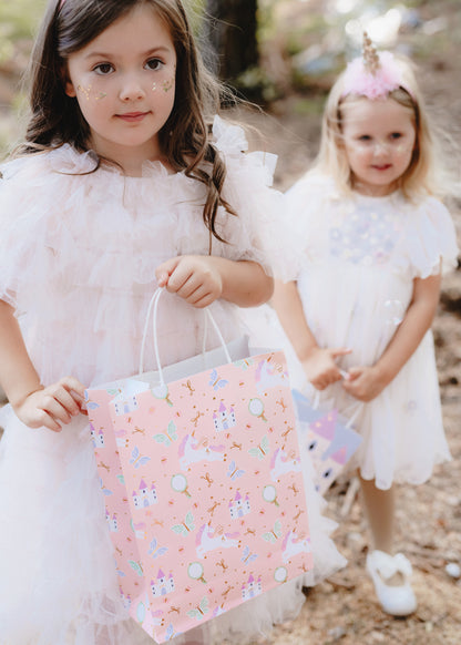 girl holding a unicorn gift bag 