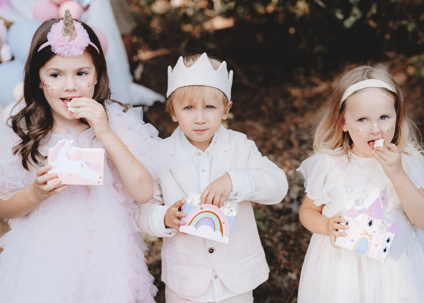 kids holding unicorn snacks boxes enjoying snacks