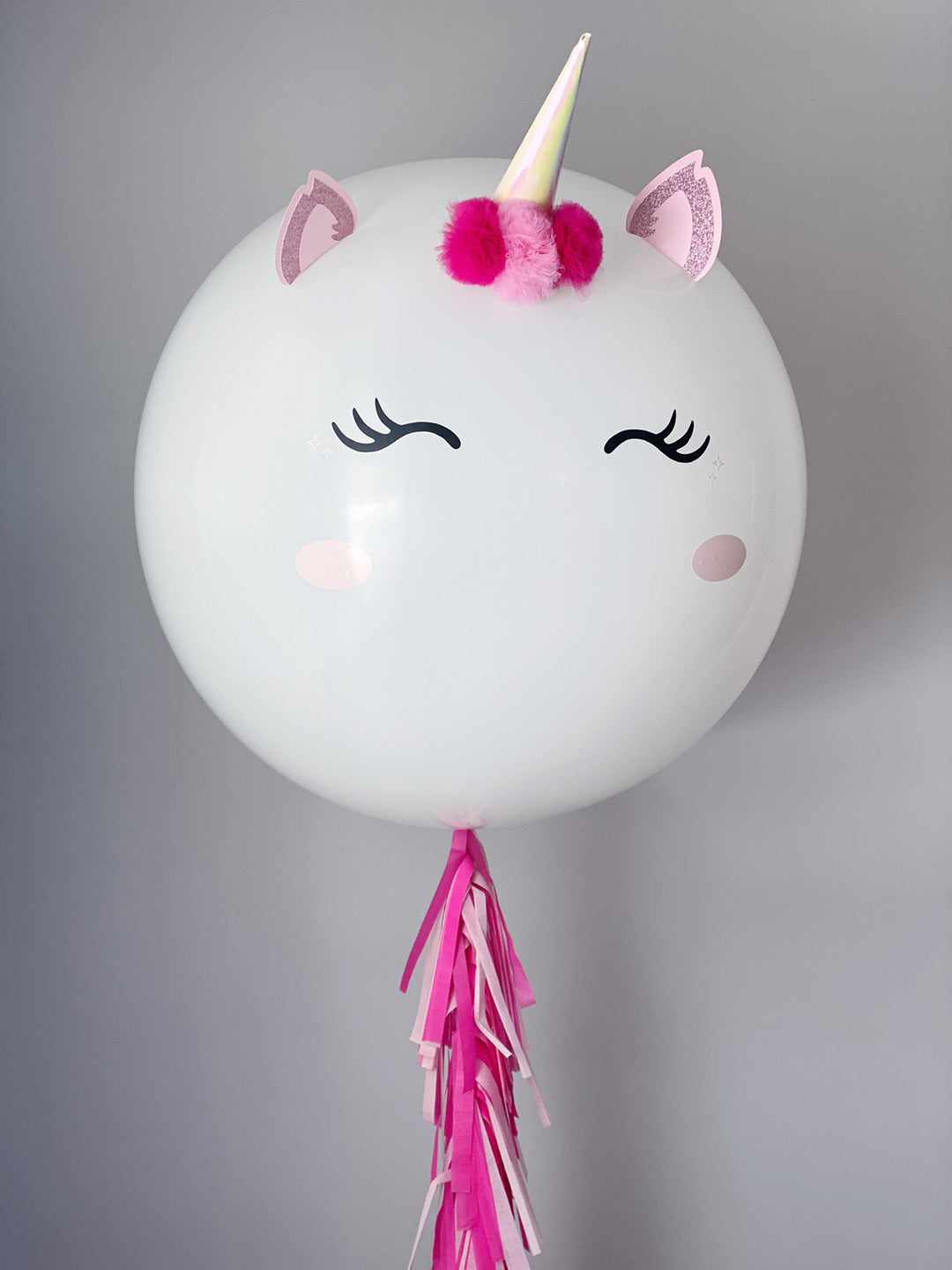 white jumbo balloon with unicorn horn and ears