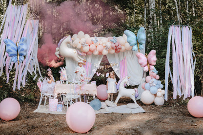 unicorn themed celebration with balloons, hanging decor and kids table 