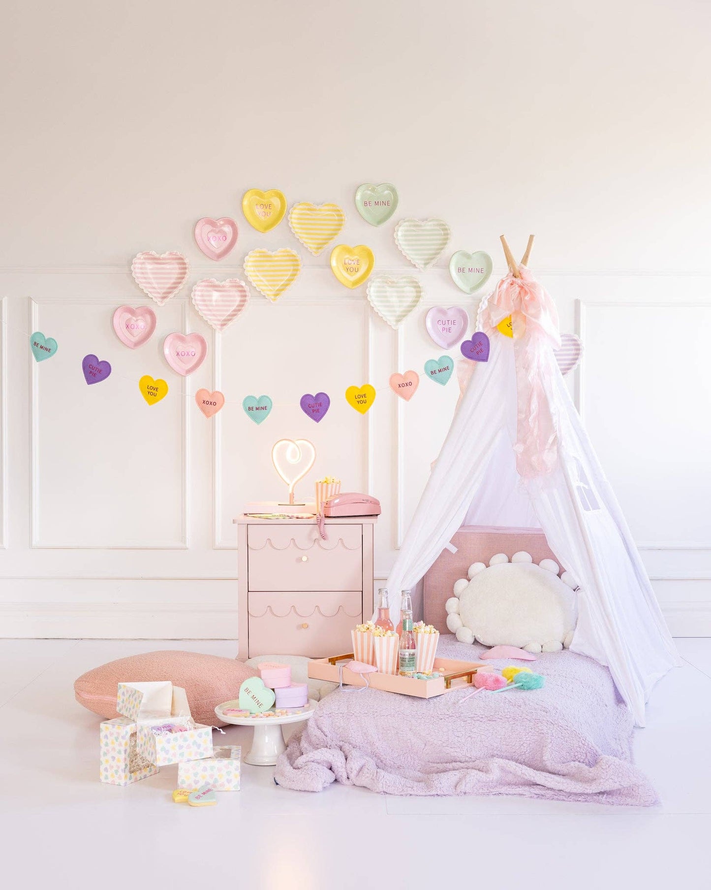 conversation hearts banner hung with teepee and matching pillows 