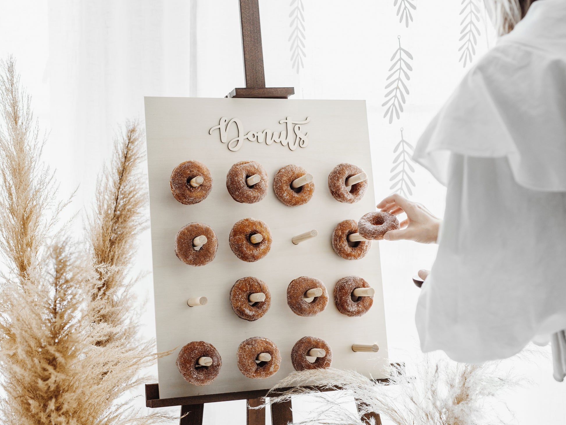 wood donut wall with donuts displayed 